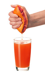 Image showing Grapefruit juice and hand