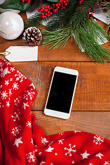 Image showing The wooden table with a phone