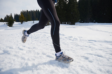 Image showing jogging on snow in forest