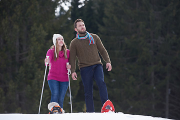 Image showing couple having fun and walking in snow shoes