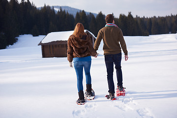 Image showing couple having fun and walking in snow shoes