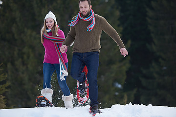 Image showing couple having fun and walking in snow shoes