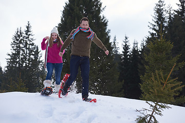 Image showing couple having fun and walking in snow shoes