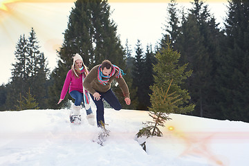 Image showing couple having fun and walking in snow shoes