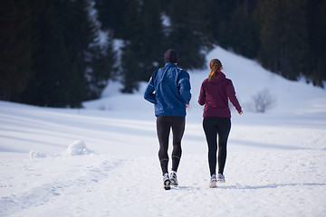 Image showing couple jogging outside on snow