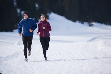 Image showing couple jogging outside on snow