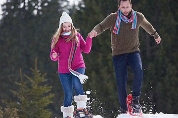 Image showing couple having fun and walking in snow shoes