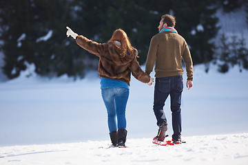 Image showing couple having fun and walking in snow shoes