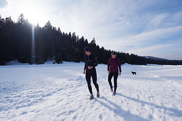 Image showing couple jogging outside on snow