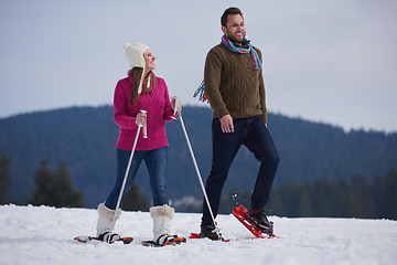 Image showing couple having fun and walking in snow shoes