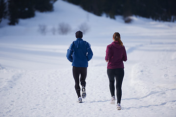 Image showing couple jogging outside on snow