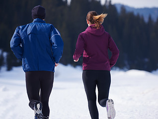 Image showing couple jogging outside on snow