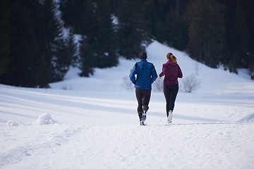 Image showing couple jogging outside on snow