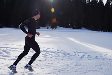 Image showing jogging on snow in forest