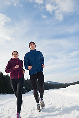 Image showing couple jogging outside on snow