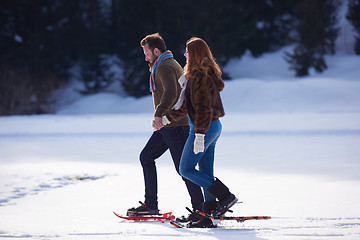 Image showing couple having fun and walking in snow shoes