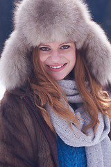 Image showing portrait of beautiful young redhair woman in snow scenery