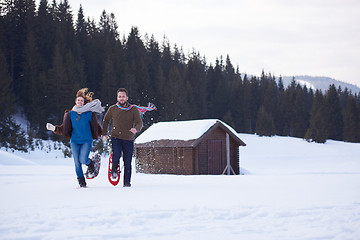 Image showing couple having fun and walking in snow shoes