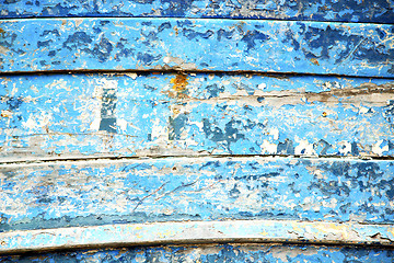 Image showing stripped paint in the blue and rusty nail