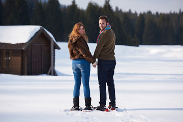 Image showing couple having fun and walking in snow shoes