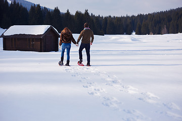 Image showing couple having fun and walking in snow shoes