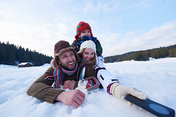 Image showing romantic couple have fun in fresh snow and taking selfie