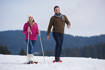 Image showing couple having fun and walking in snow shoes