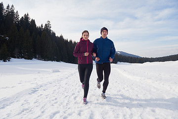 Image showing couple jogging outside on snow