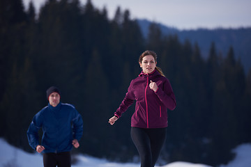 Image showing couple jogging outside on snow