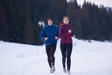 Image showing couple jogging outside on snow