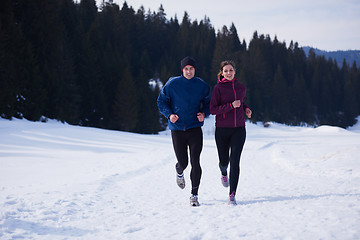 Image showing couple jogging outside on snow