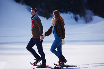 Image showing couple having fun and walking in snow shoes