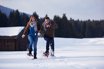 Image showing couple having fun and walking in snow shoes