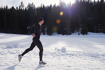 Image showing jogging on snow in forest