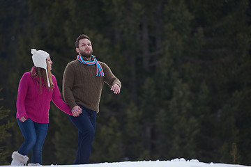 Image showing couple having fun and walking in snow shoes