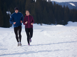 Image showing couple jogging outside on snow