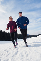 Image showing couple jogging outside on snow