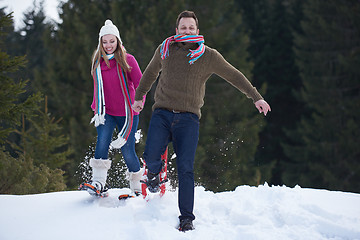 Image showing couple having fun and walking in snow shoes