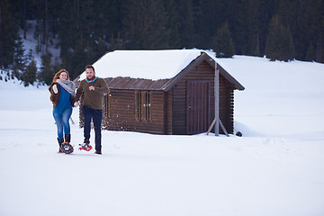 Image showing couple having fun and walking in snow shoes