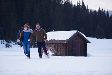 Image showing couple having fun and walking in snow shoes