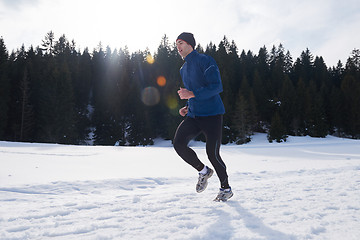 Image showing jogging on snow in forest