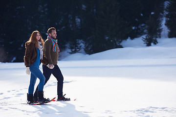 Image showing couple having fun and walking in snow shoes