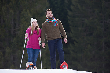 Image showing couple having fun and walking in snow shoes