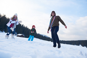 Image showing happy family playing together in snow at winter