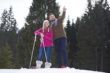 Image showing couple having fun and walking in snow shoes