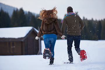 Image showing couple having fun and walking in snow shoes