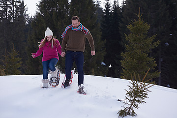 Image showing couple having fun and walking in snow shoes