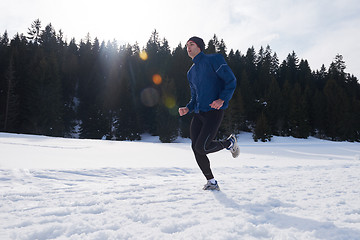 Image showing jogging on snow in forest