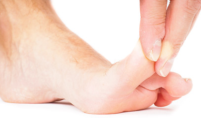 Image showing Male person pulling big toe backwards isolated towards white