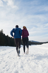 Image showing couple jogging outside on snow